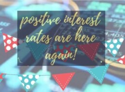 Its a blue based picture with a banner saying 'positive interest rates are here again' It is an illustration for Charles Gillams's blog post dated April 2022