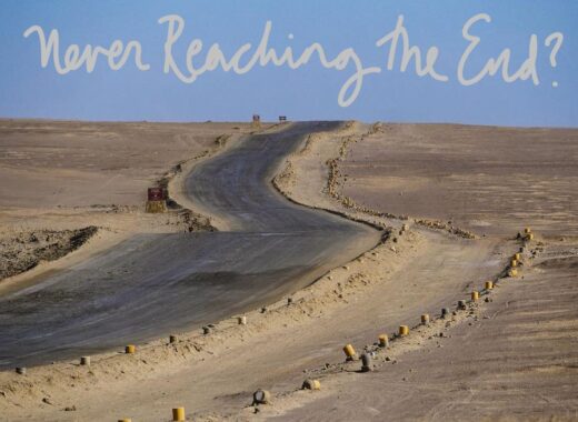this is a photograph of a desert road, with the words written above : never reaching the end?